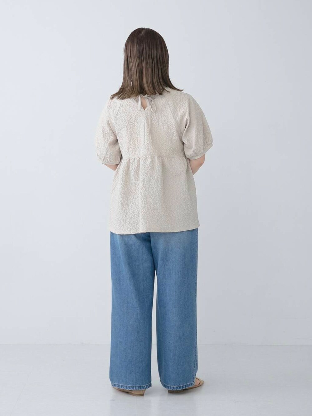 ベージュ系のシャツ/ブラウス、ブルー系のデニムパンツを着用したレディースの夏コーディネートの4枚目の写真