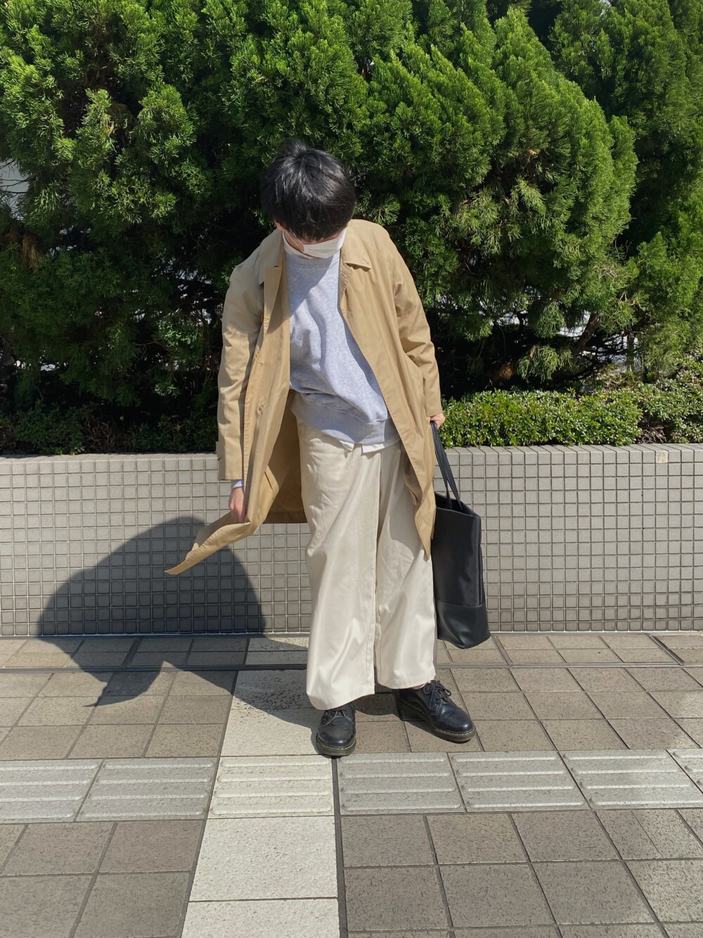 ブラック系のその他シューズ、ホワイト系のスラックス、ブラック系のトートバッグを着用したメンズの春コーディネートの2枚目の写真