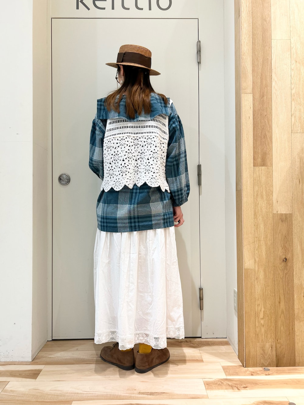 グリーン系のシャツ/ブラウス、ホワイト系のベスト、ホワイト系のスカートを着用したレディースの春コーディネートの4枚目の写真