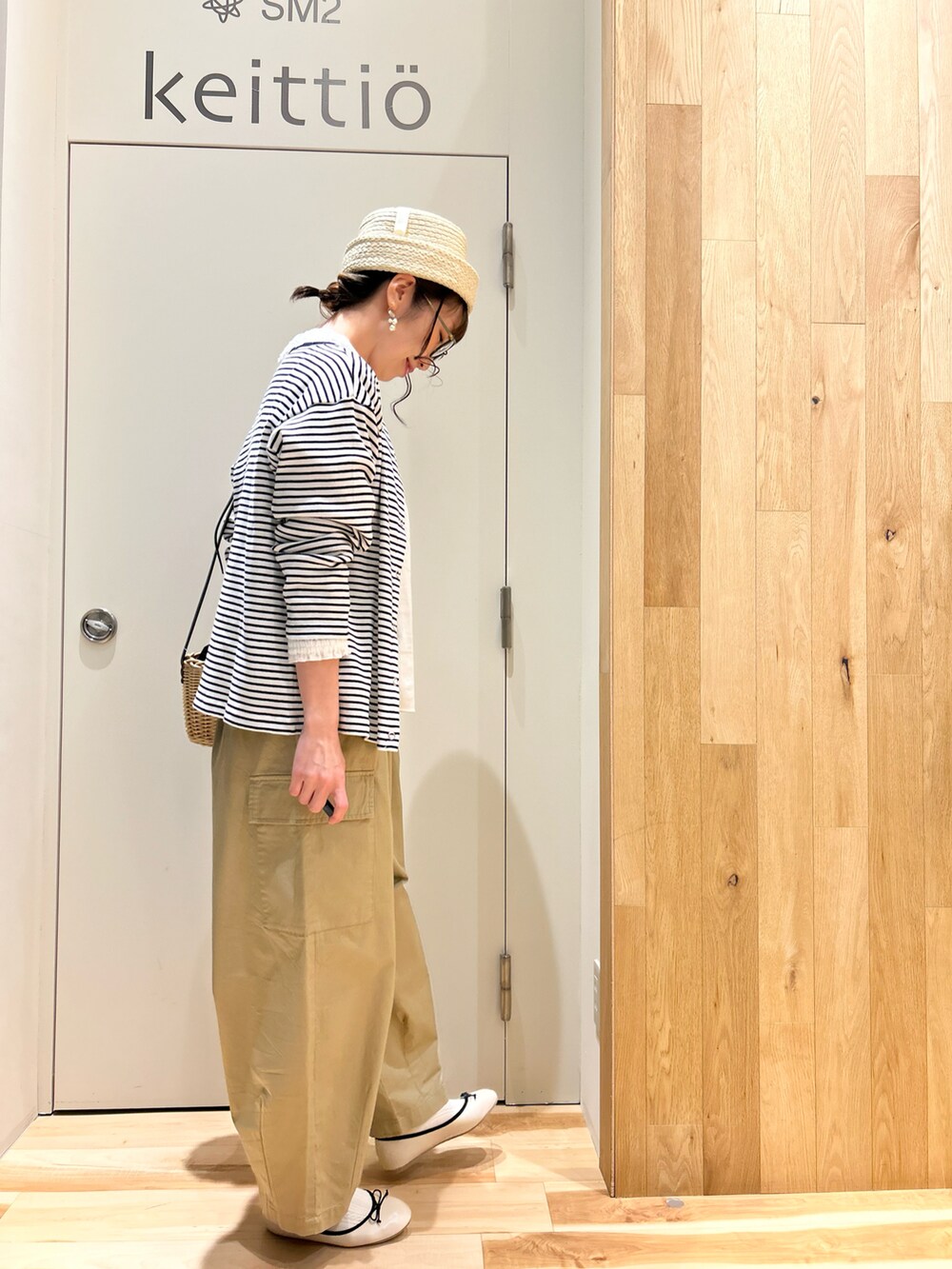 ホワイト系のシャツ/ブラウス、ブラック系のカーディガン/ボレロ、ブラック系のハンドバッグを着用したレディースの春コーディネートの2枚目の写真