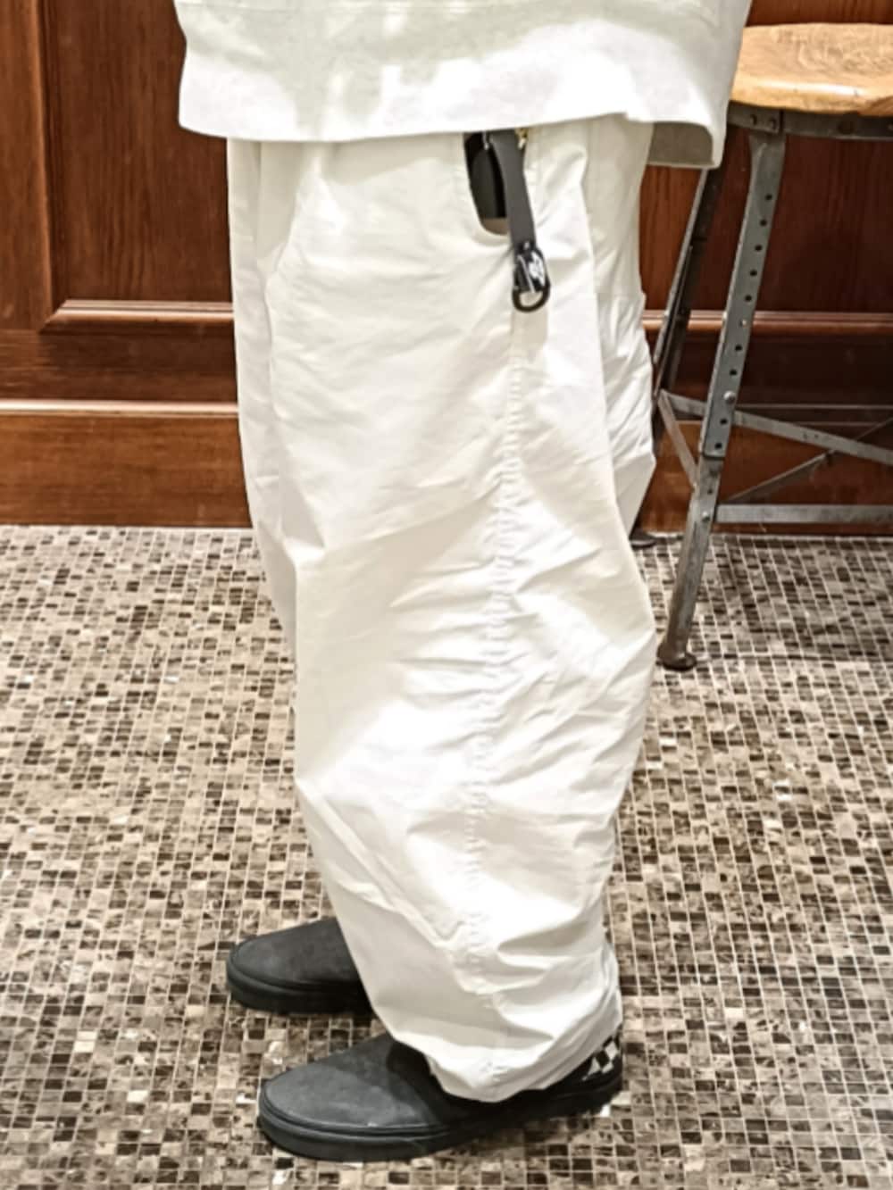 グレー系のスウェット、ホワイト系のパンツ、グレー系のスリッポンを着用したメンズの春コーディネートの4枚目の写真