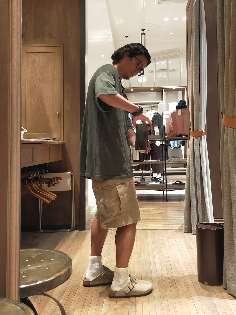 グリーン系のポロシャツ、ベージュ系のパンツ、ベージュ系のサンダルを着用したメンズの夏コーディネートの2枚目の写真