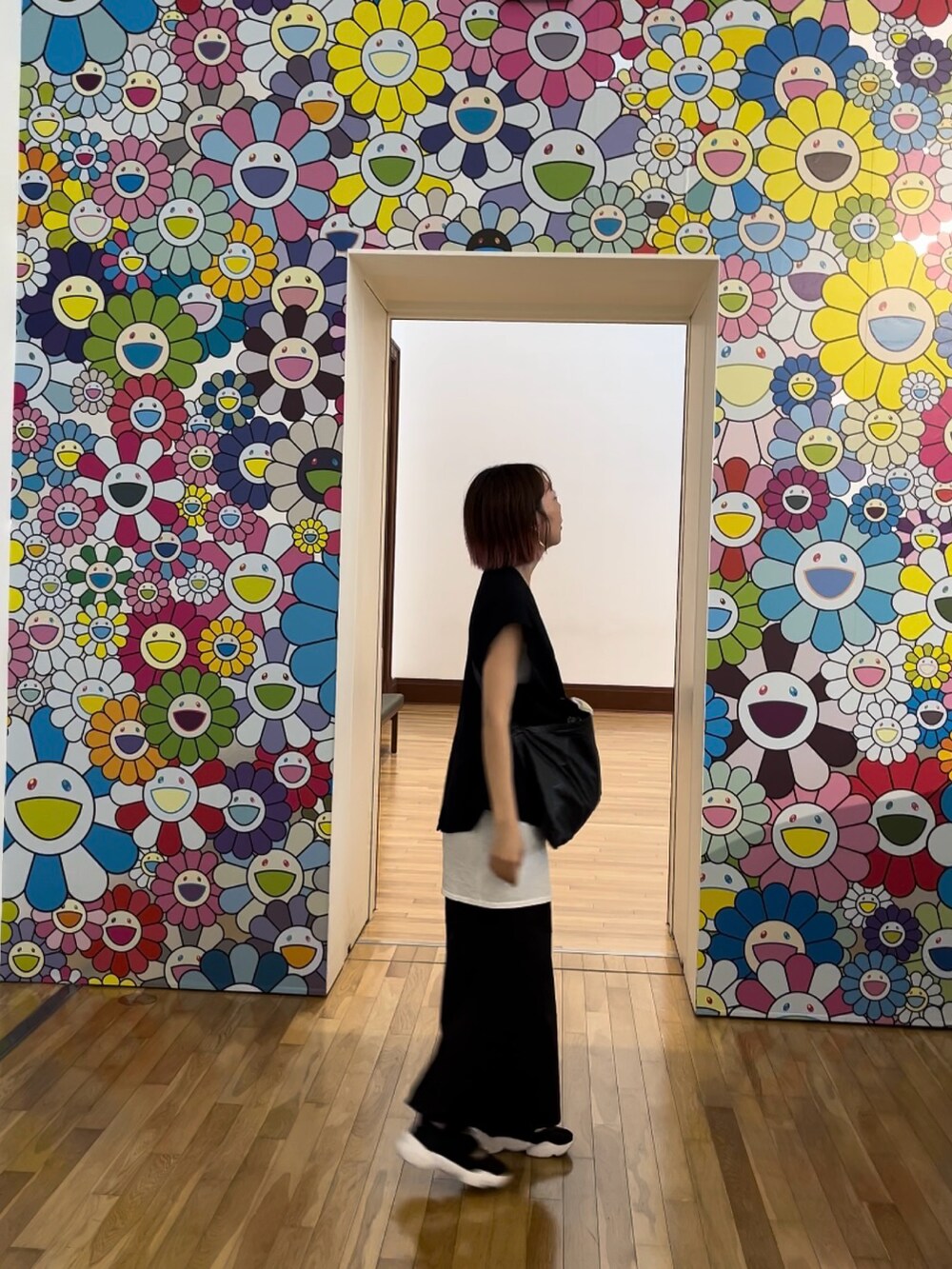 ブラック系のスカート、ホワイト系のタンクトップ、ブラック系のショルダーバッグを着用したレディースの夏コーディネートの4枚目の写真