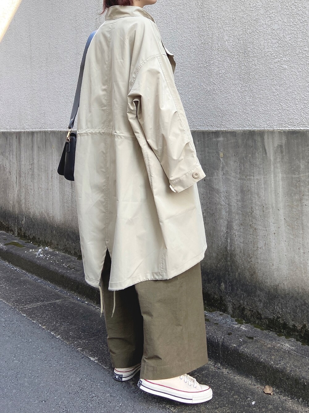 ベージュ系のモッズコート、ホワイト系のTシャツ/カットソー、グリーン系のその他パンツを着用したレディースの秋コーディネートの3枚目の写真