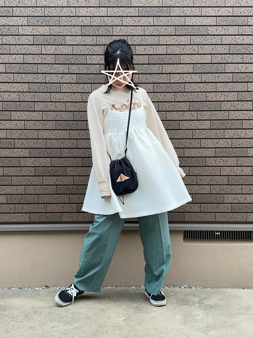 グリーン系のその他パンツ、ホワイト系のワンピース、ブラック系のスニーカーを着用したレディースの春コーディネートの2枚目の写真