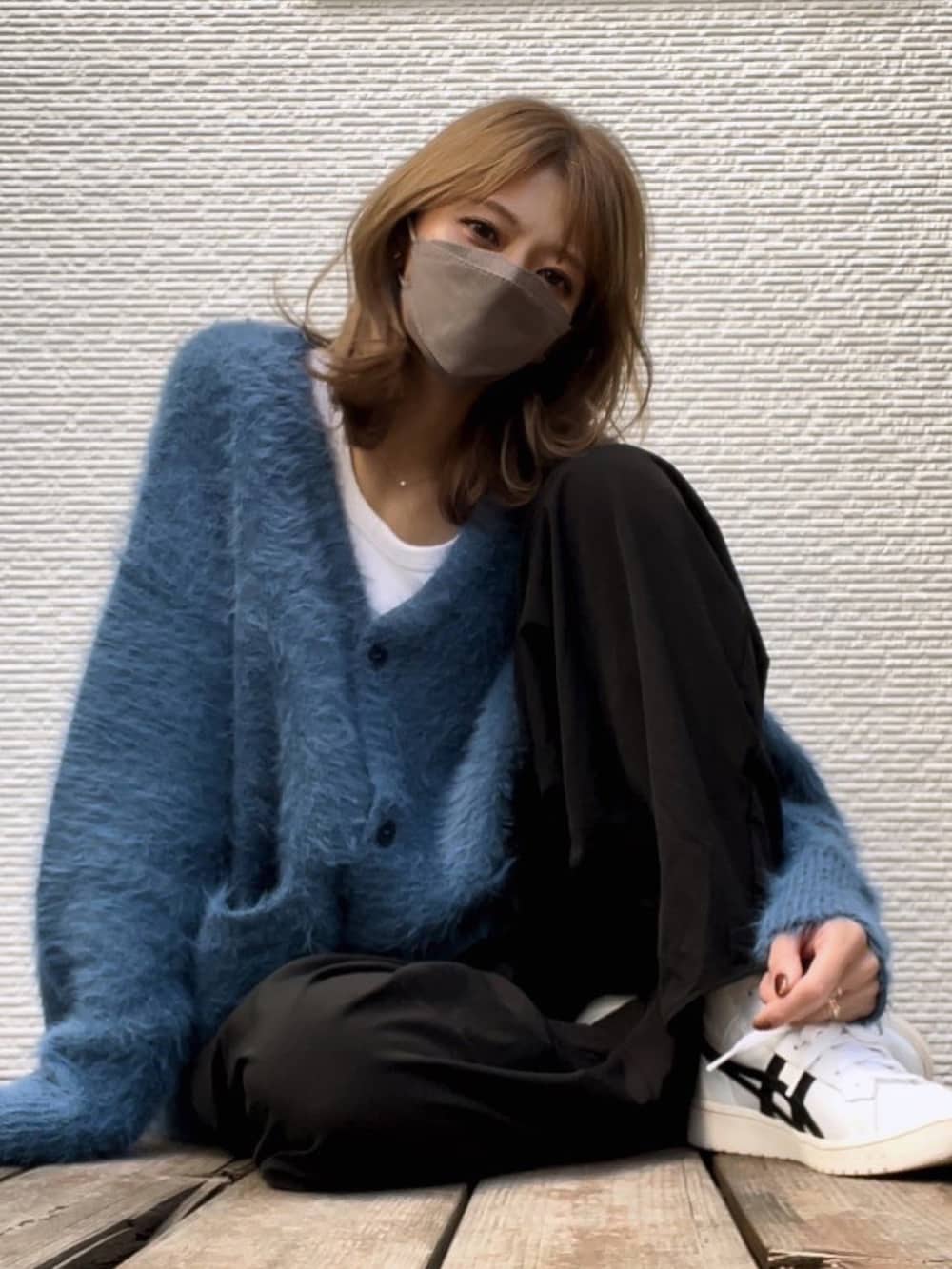 ホワイト系のスニーカーを着用したレディースの秋コーディネートの2枚目の写真