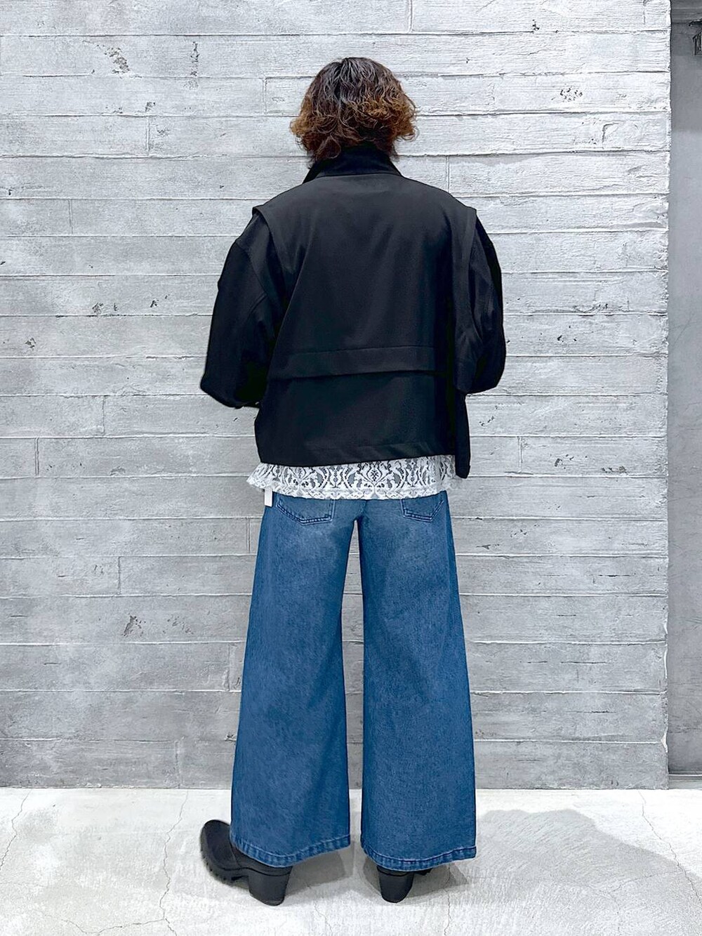 ブルー系のデニムパンツ、ブラック系のドレスシューズ、グレー系のスウェットを着用したメンズの春コーディネートの2枚目の写真