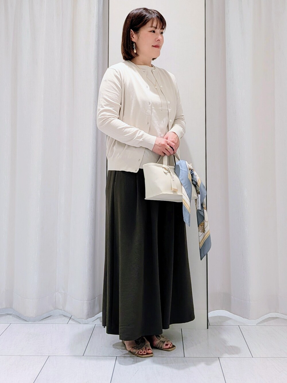 ベージュ系のカーディガン/ボレロ、ベージュ系のニット/セーター、ブラウン系のその他パンツを着用したレディースの夏コーディネートの4枚目の写真