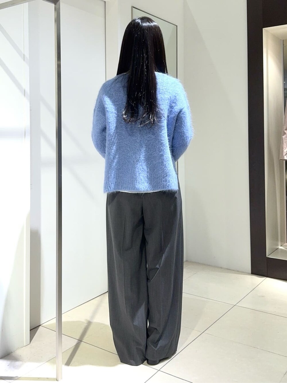 ブルー系のニット/セーター、グレー系のその他パンツを着用したレディースの秋コーディネートの2枚目の写真