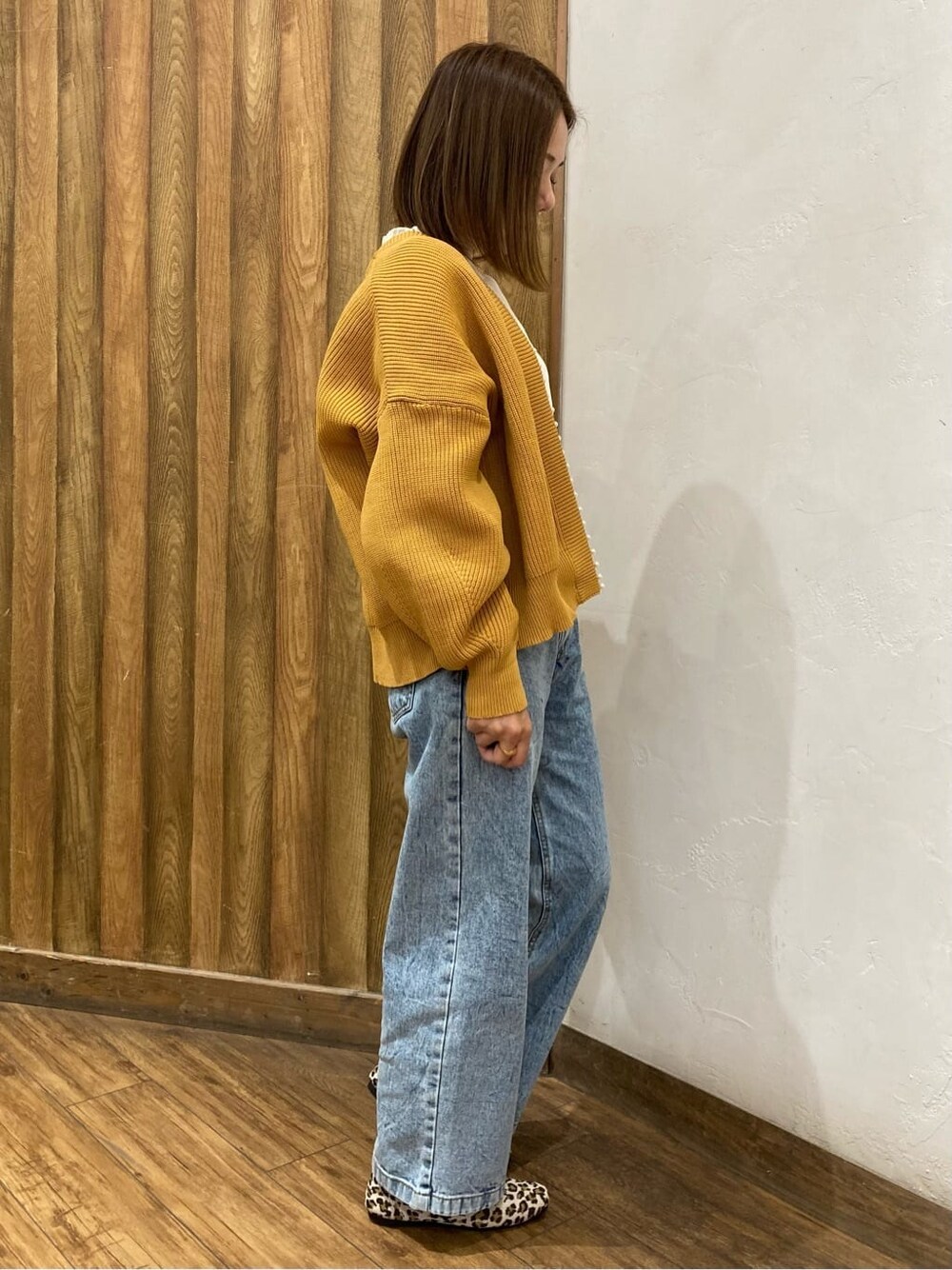 イエロー系のパンプスを着用したレディースの秋コーディネートの2枚目の写真