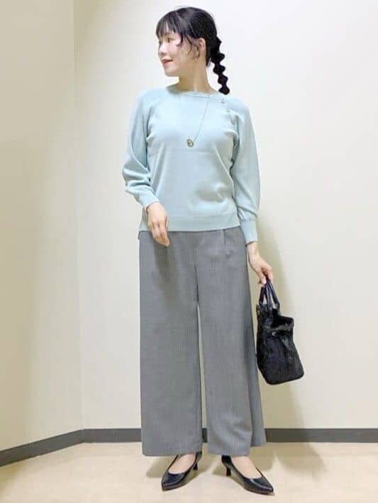 グリーン系のニット/セーター、グレー系のその他パンツ、ブラック系のトートバッグを着用したレディースの冬コーディネートの7枚目の写真