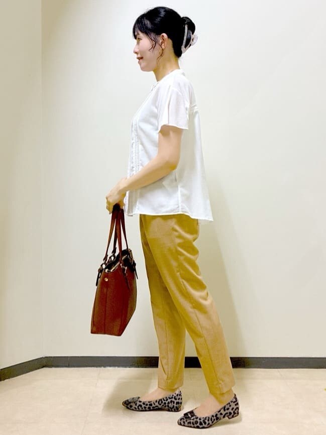 ホワイト系のシャツ/ブラウス、イエロー系のその他パンツ、ブラウン系のトートバッグを着用したレディースの秋コーディネートの2枚目の写真