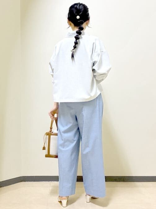 グレー系のブルゾン、ブラウン系のニット/セーター、ブルー系のその他パンツを着用したレディースの春コーディネートの3枚目の写真