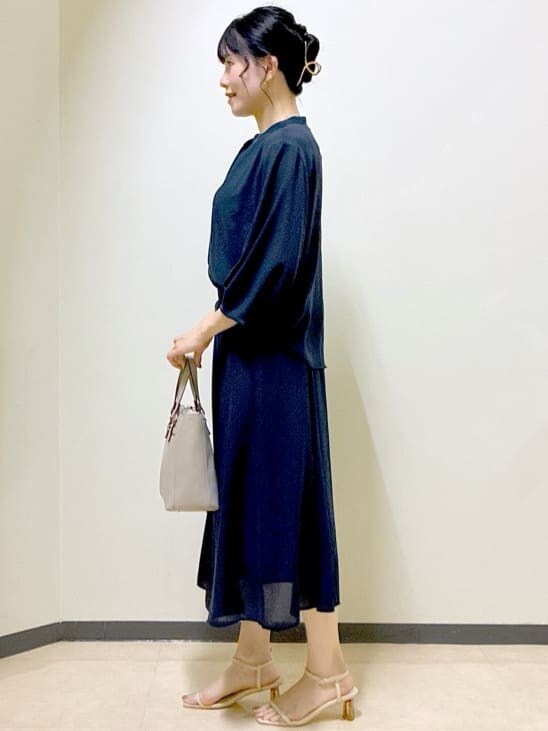 ブルー系のシャツ/ブラウス、ブルー系のスカート、ベージュ系のニット/セーターを着用したレディースの夏コーディネートの2枚目の写真