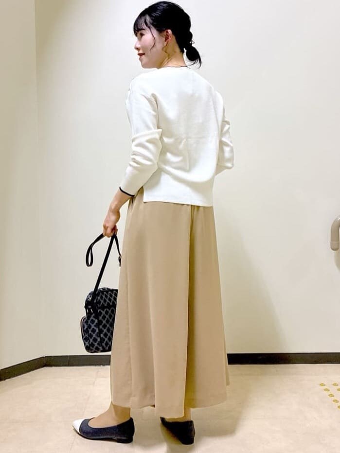 ホワイト系のニット/セーター、イエロー系のその他パンツ、ブルー系のショルダーバッグを着用したレディースの春コーディネートの4枚目の写真