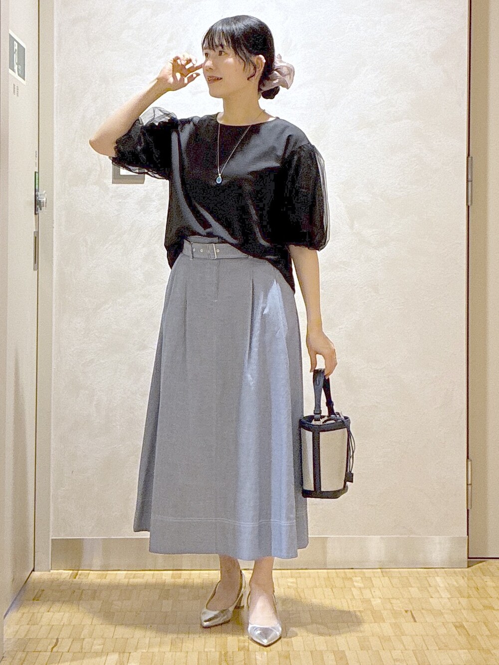 ブラック系のTシャツ/カットソー、ブルー系のスカート、ブルー系のショルダーバッグを着用したレディースの夏コーディネートの6枚目の写真