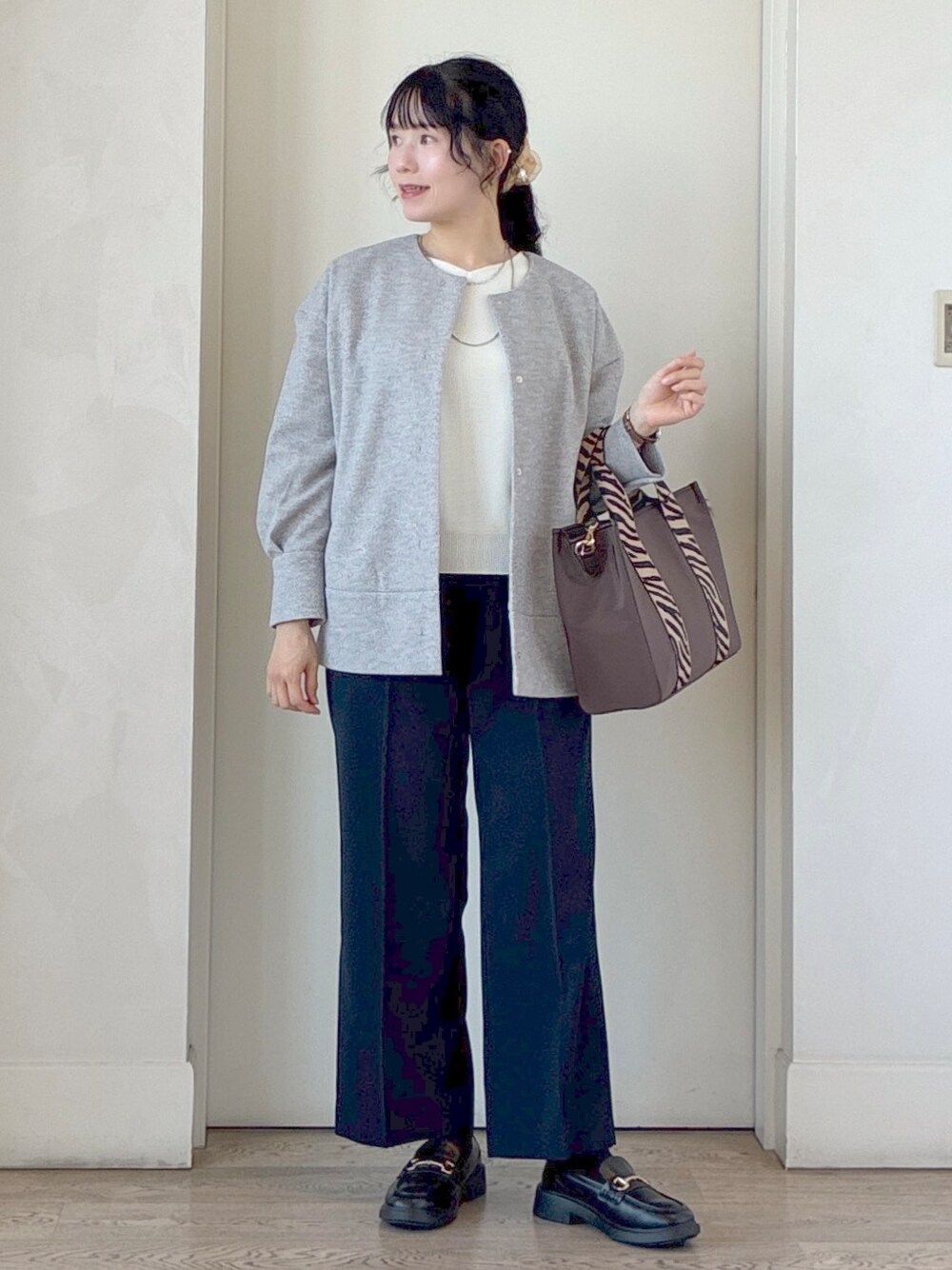ブルー系のその他パンツ、ブラウン系のトートバッグ、シルバー系のネックレスを着用したレディースの秋コーディネートの8枚目の写真