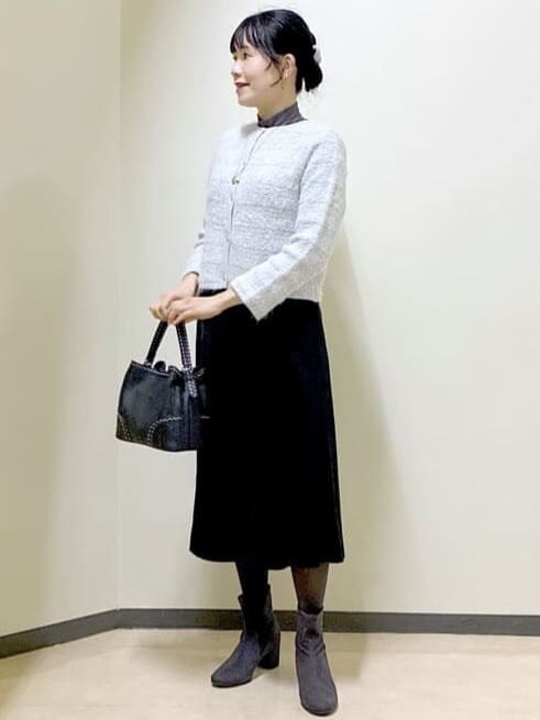 グレー系のカーディガン/ボレロ、グレー系のニット/セーター、ブラック系のスカートを着用したレディースの冬コーディネートの8枚目の写真