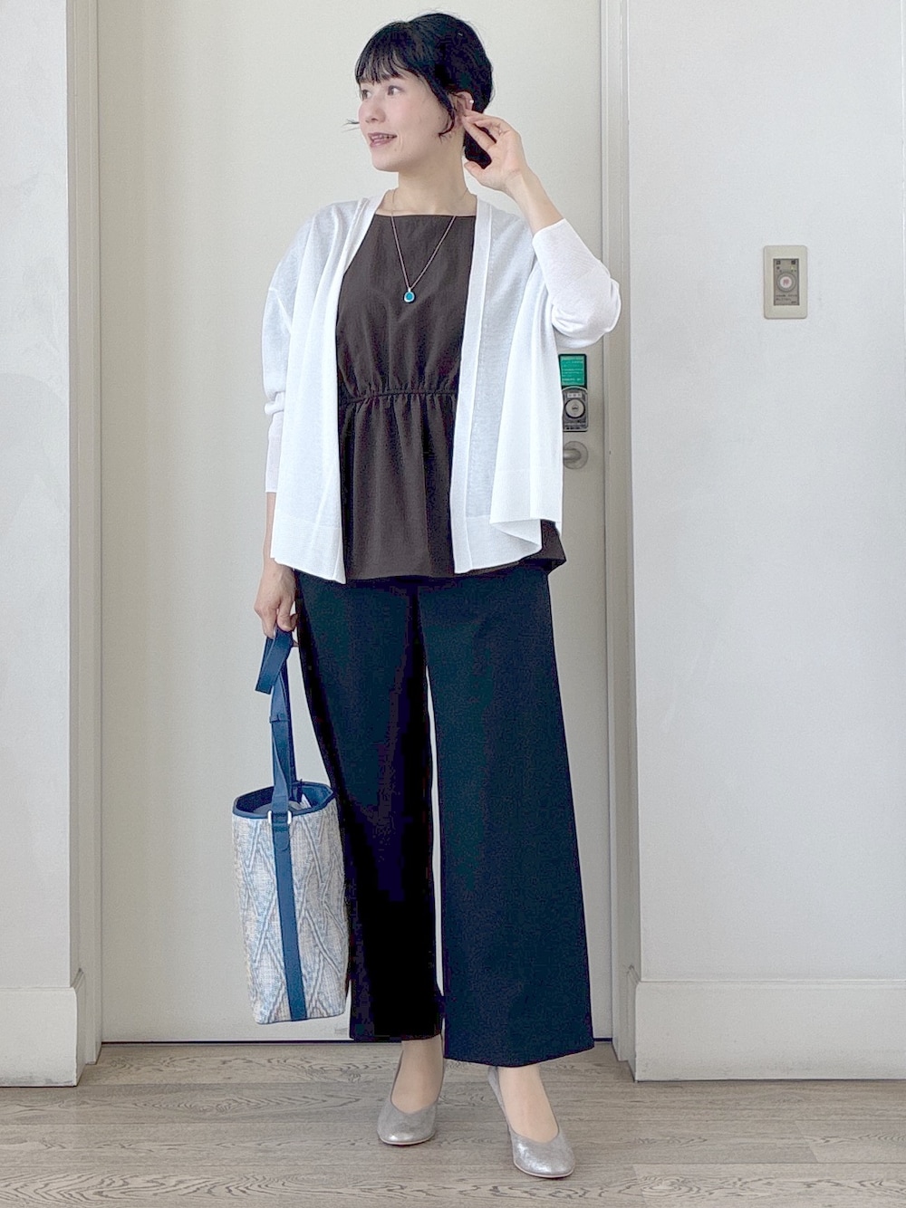 ブラック系のその他パンツ、ブルー系のショルダーバッグ、ホワイト系のカーディガン/ボレロを着用したレディースの春コーディネートの10枚目の写真