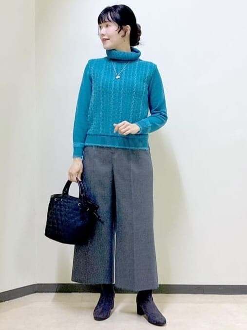 ブルー系のニット/セーター、グレー系のその他パンツ、ブラック系のダウンジャケット/コートを着用したレディースの冬コーディネートの8枚目の写真