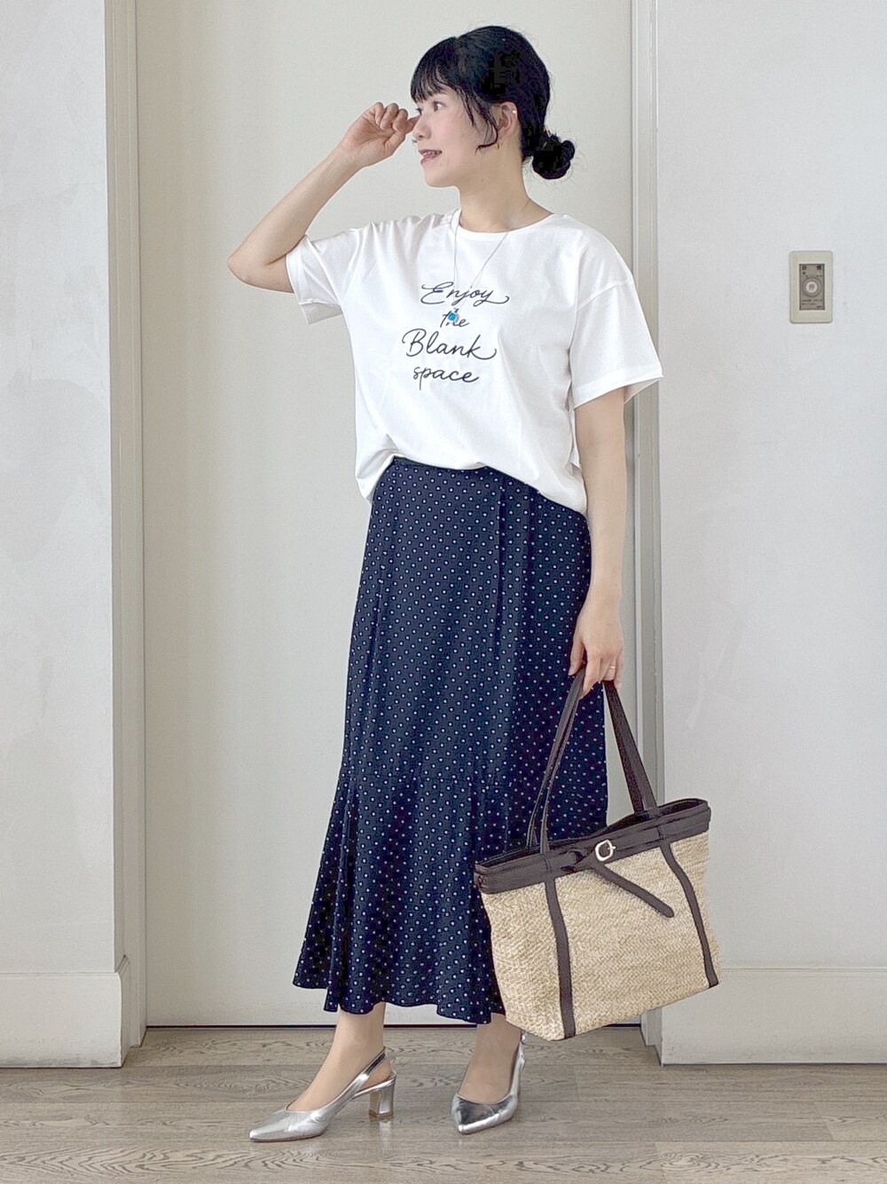 ホワイト系のTシャツ/カットソー、ベージュ系のベスト、ブルー系のスカートを着用したレディースの春コーディネートの5枚目の写真