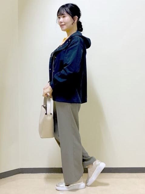 ブルー系のブルゾン、オレンジ系のニット/セーター、ベージュ系のその他パンツを着用したレディースの春コーディネートの2枚目の写真