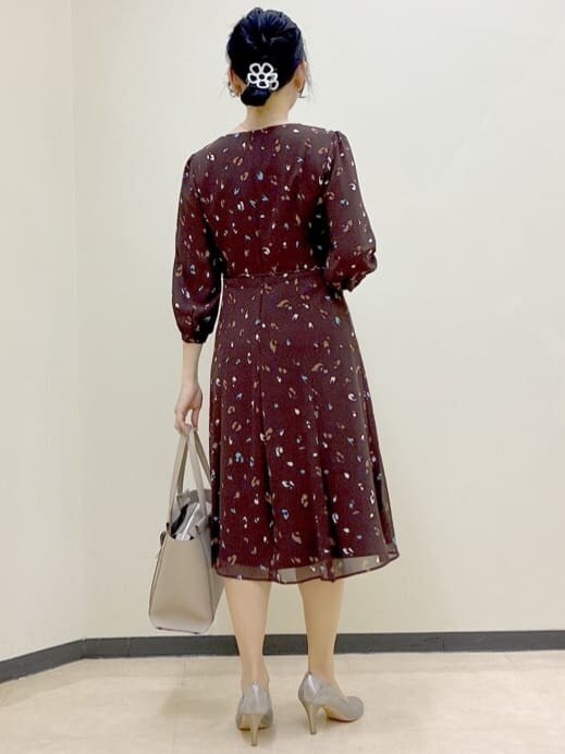 ブラウン系のワンピース、ホワイト系のカーディガン/ボレロ、ベージュ系のトートバッグを着用したレディースの春コーディネートの3枚目の写真