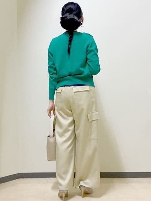 ベージュ系のその他パンツ、ベージュ系のショルダーバッグ、グリーン系のニット/セーターを着用したレディースの春コーディネートの3枚目の写真