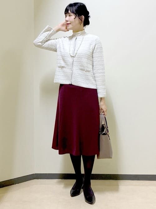 グレー系のカーディガン/ボレロ、ベージュ系のニット/セーター、レッド系のスカートを着用したレディースの冬コーディネートの6枚目の写真