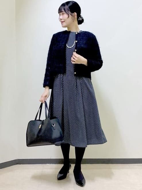 ブラック系のカーディガン/ボレロ、グレー系のワンピース、ブラック系のボストンバッグを着用したレディースの冬コーディネートの5枚目の写真