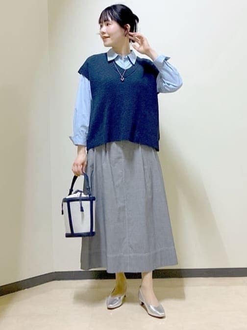 ブルー系のニット/セーター、ブルー系のシャツ/ブラウス、ブラック系のスカートを着用したレディースの春コーディネートの5枚目の写真