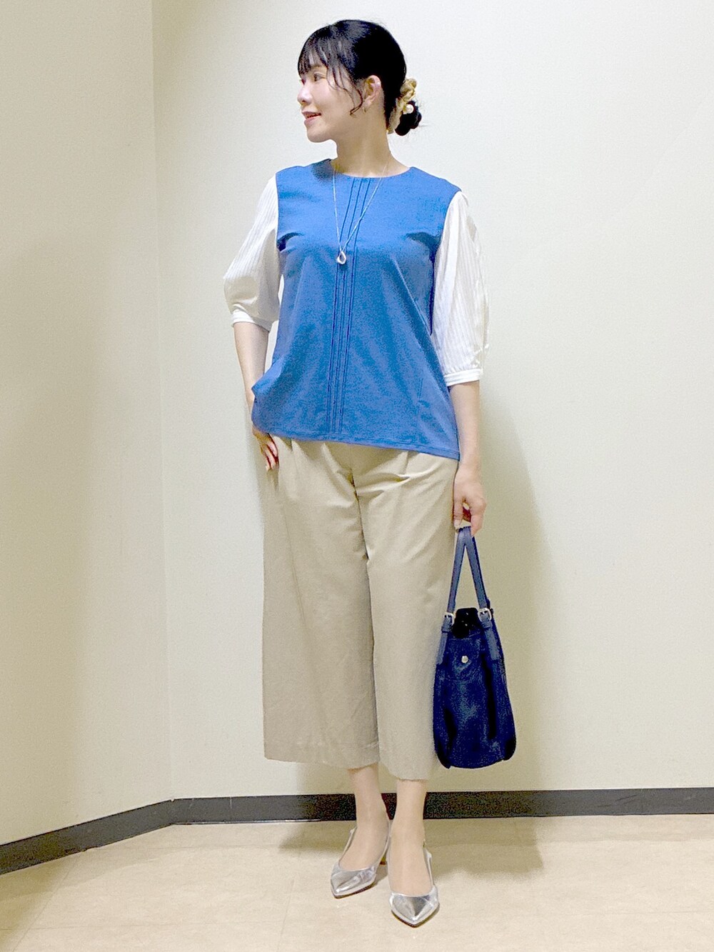 ブルー系のTシャツ/カットソー、ベージュ系のその他パンツ、ブルー系のショルダーバッグを着用したレディースの春コーディネートの9枚目の写真