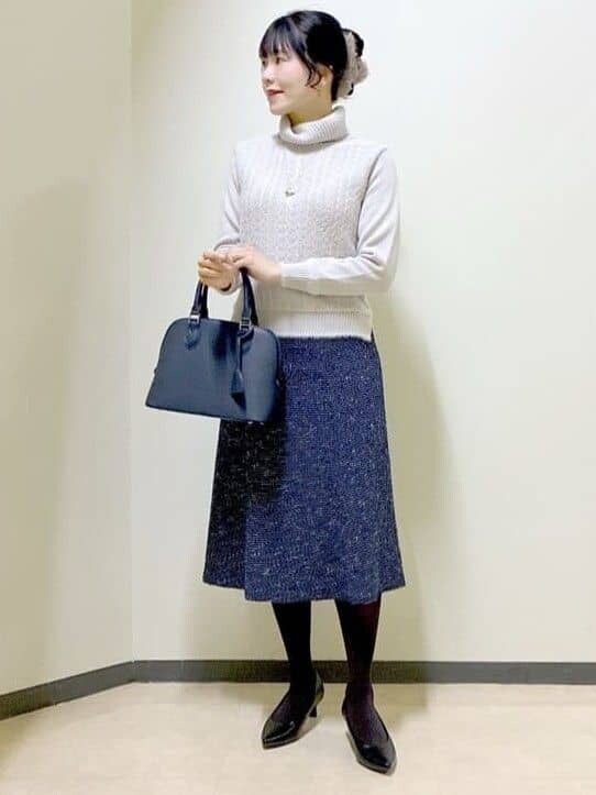 グレー系のニット/セーター、ブルー系のスカート、ブルー系のハンドバッグを着用したレディースの冬コーディネートの8枚目の写真