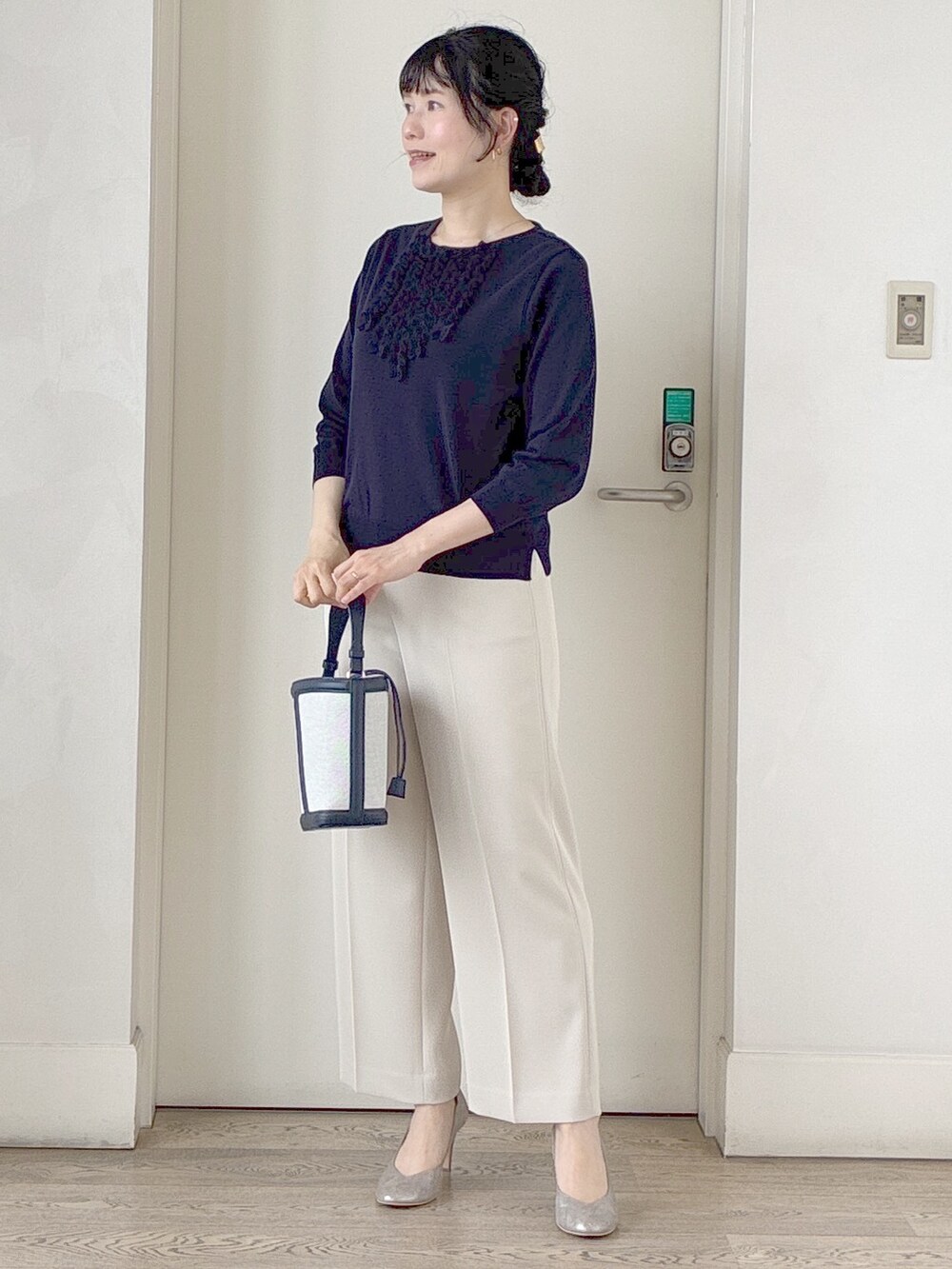 ブルー系のニット/セーター、ベージュ系のその他パンツ、ブルー系のショルダーバッグを着用したレディースの夏コーディネートの8枚目の写真