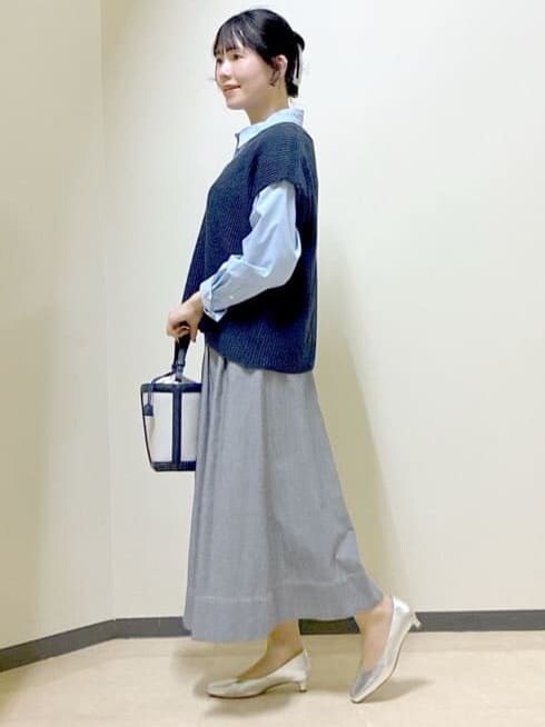 ブルー系のニット/セーター、ブルー系のシャツ/ブラウス、ブラック系のスカートを着用したレディースの春コーディネートの2枚目の写真