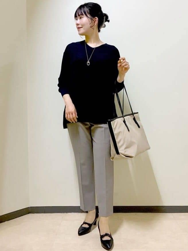 ブルー系のニット/セーター、ブラウン系のその他パンツ、ベージュ系のトートバッグを着用したレディースの春コーディネートの6枚目の写真