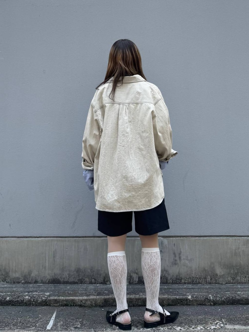 ブラック系のパンプス、ブラック系のスラックス、ブルー系のシャツ/ブラウスを着用したレディースの春コーディネートの7枚目の写真