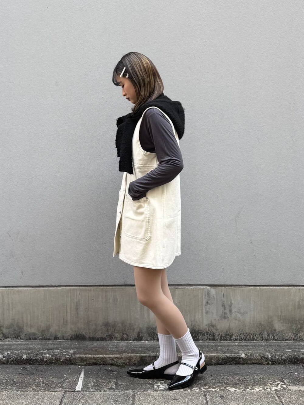 ブラック系のパンプス、ホワイト系のワンピース、グレー系のTシャツ/カットソーを着用したレディースの春コーディネートの5枚目の写真