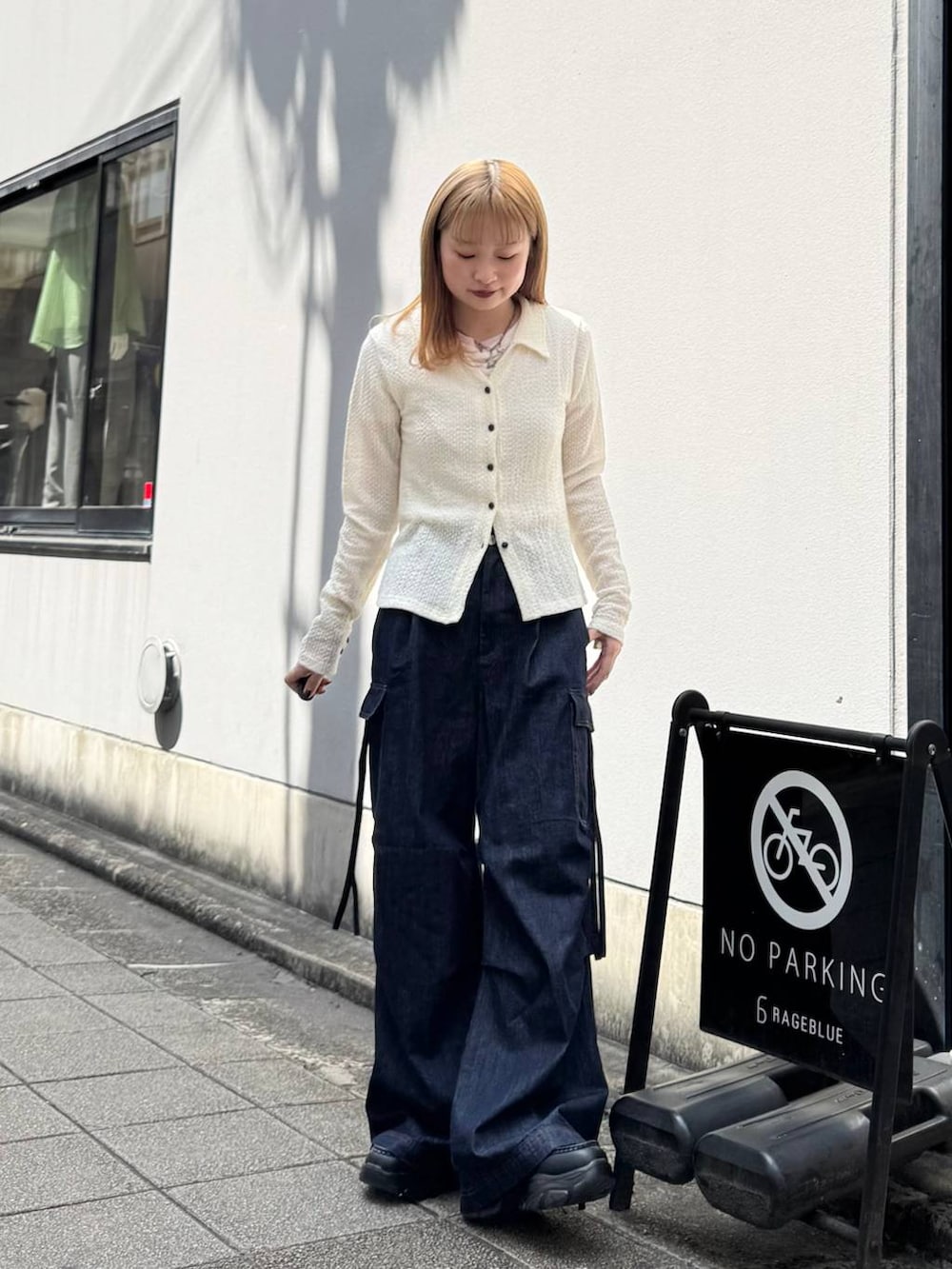 ブラック系のローファー、ブルー系のデニムパンツ、ホワイト系のカーディガン/ボレロを着用したレディースの春コーディネートの6枚目の写真