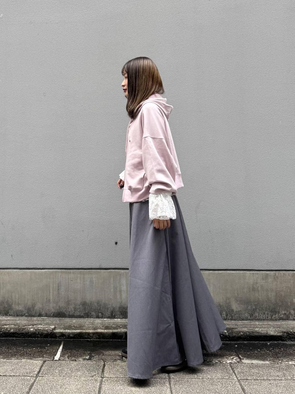 ホワイト系のTシャツ/カットソー、グレー系のスカート、ピンク系のパーカーを着用したレディースの春コーディネートの6枚目の写真