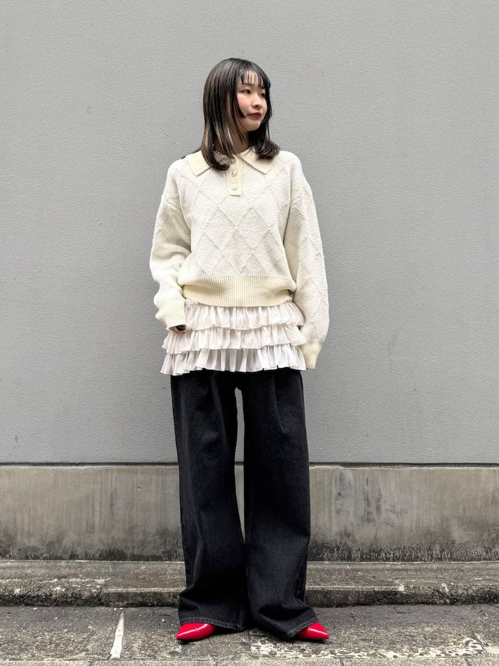 レッド系のパンプス、ブラック系のデニムパンツ、ホワイト系のTシャツ/カットソーを着用したレディースの春コーディネートの3枚目の写真