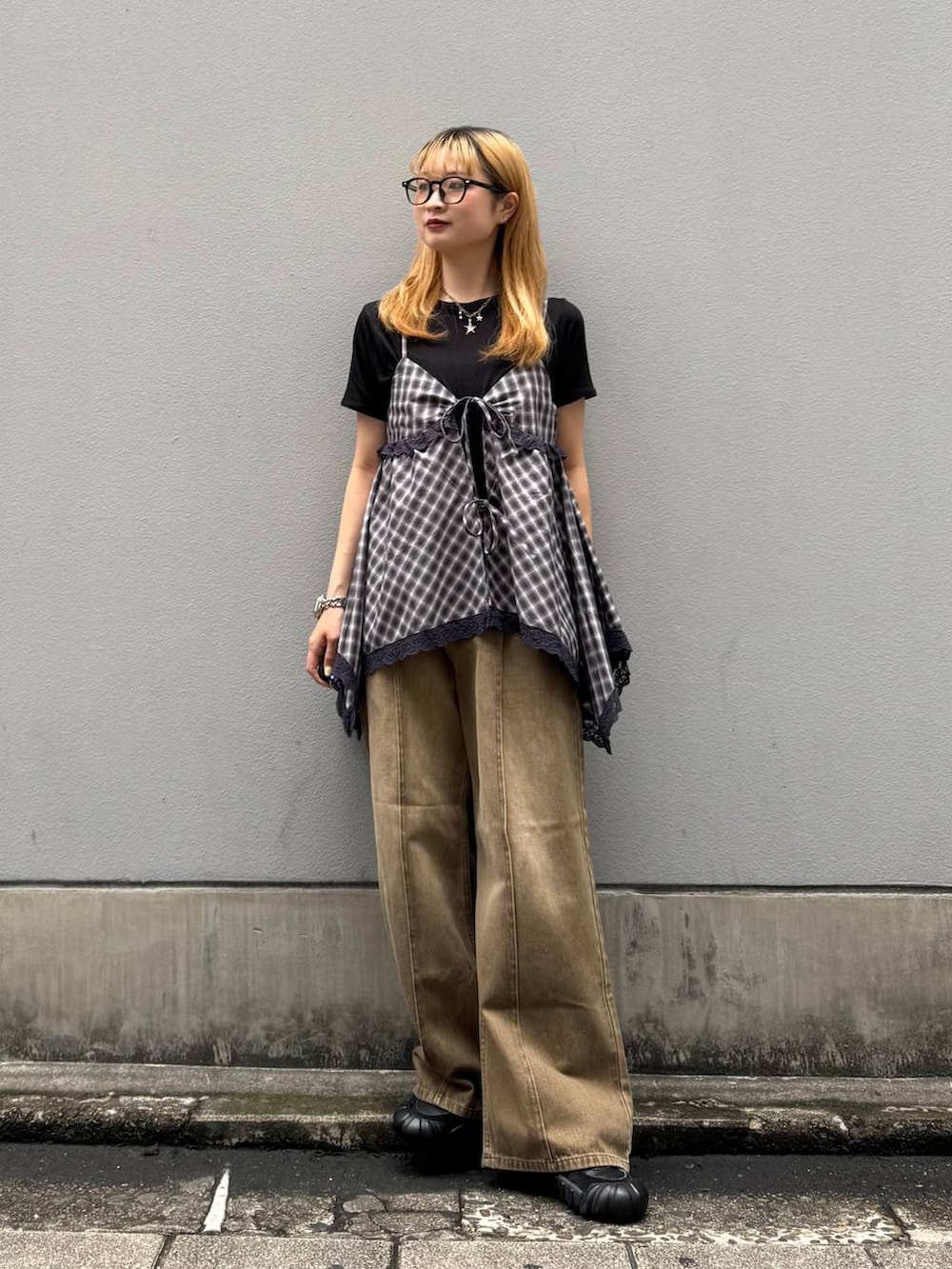 ブラック系のTシャツ/カットソー、ブラウン系のデニムパンツ、ホワイト系のキャミソールを着用したレディースの夏コーディネートの3枚目の写真