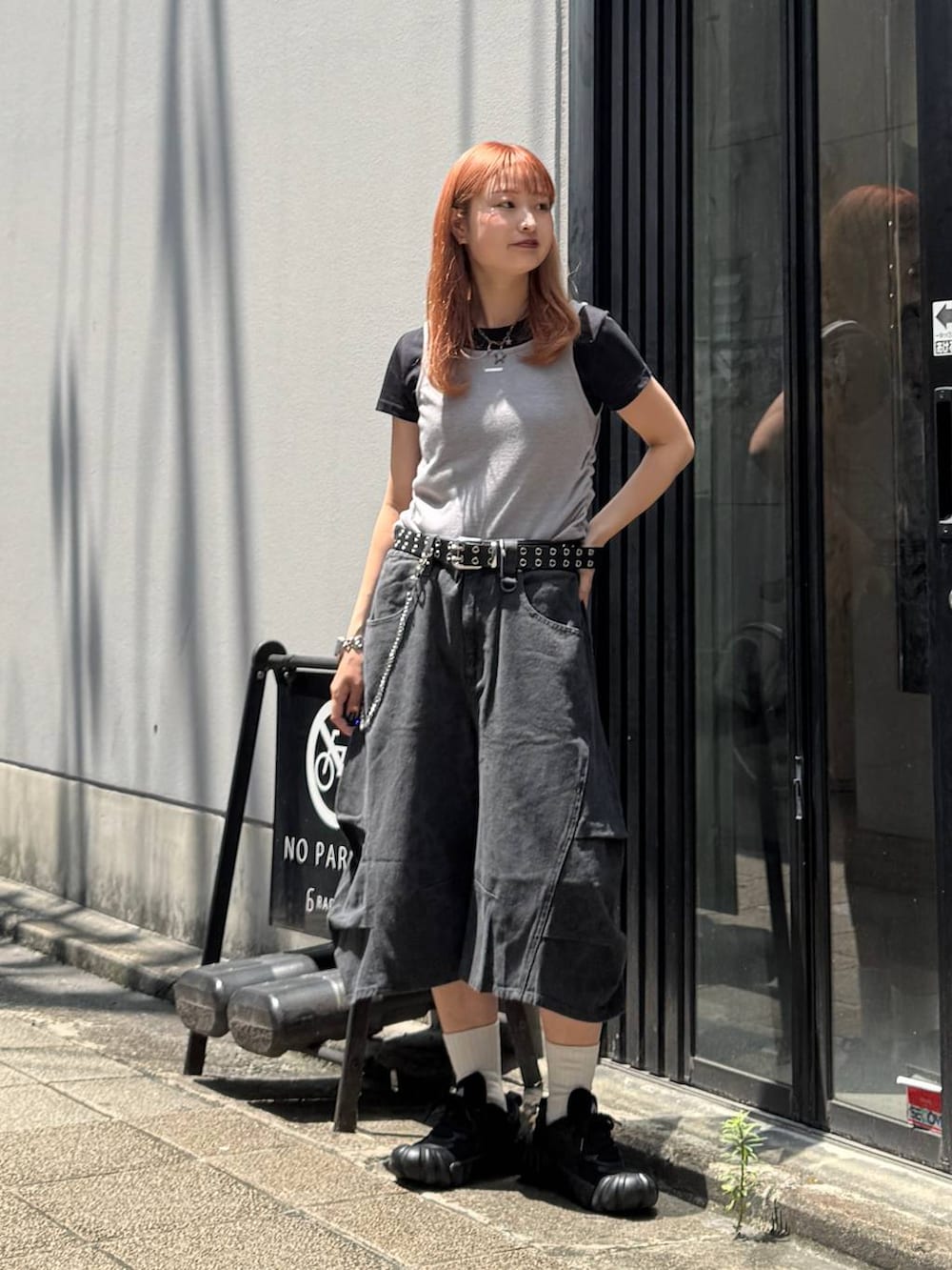 グレー系のデニムパンツ、ブルー系のTシャツ/カットソー、ブラック系のベルトを着用したレディースの夏コーディネートの2枚目の写真