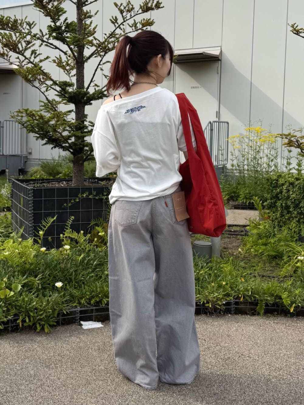 ホワイト系のTシャツ/カットソー、レッド系のトートバッグを着用したレディースの夏コーディネートの3枚目の写真