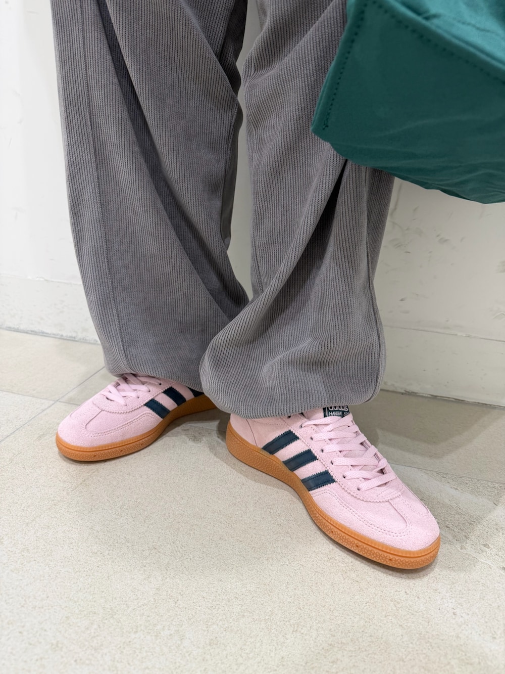 グレー系のテーラードジャケット、ホワイト系のTシャツ/カットソー、グリーン系のトートバッグを着用したレディースの冬コーディネートの6枚目の写真