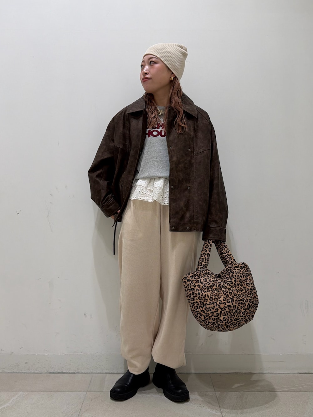 グレー系のスウェット、ブラウン系のその他アウター、ホワイト系のその他パンツを着用したレディースの冬コーディネートの2枚目の写真