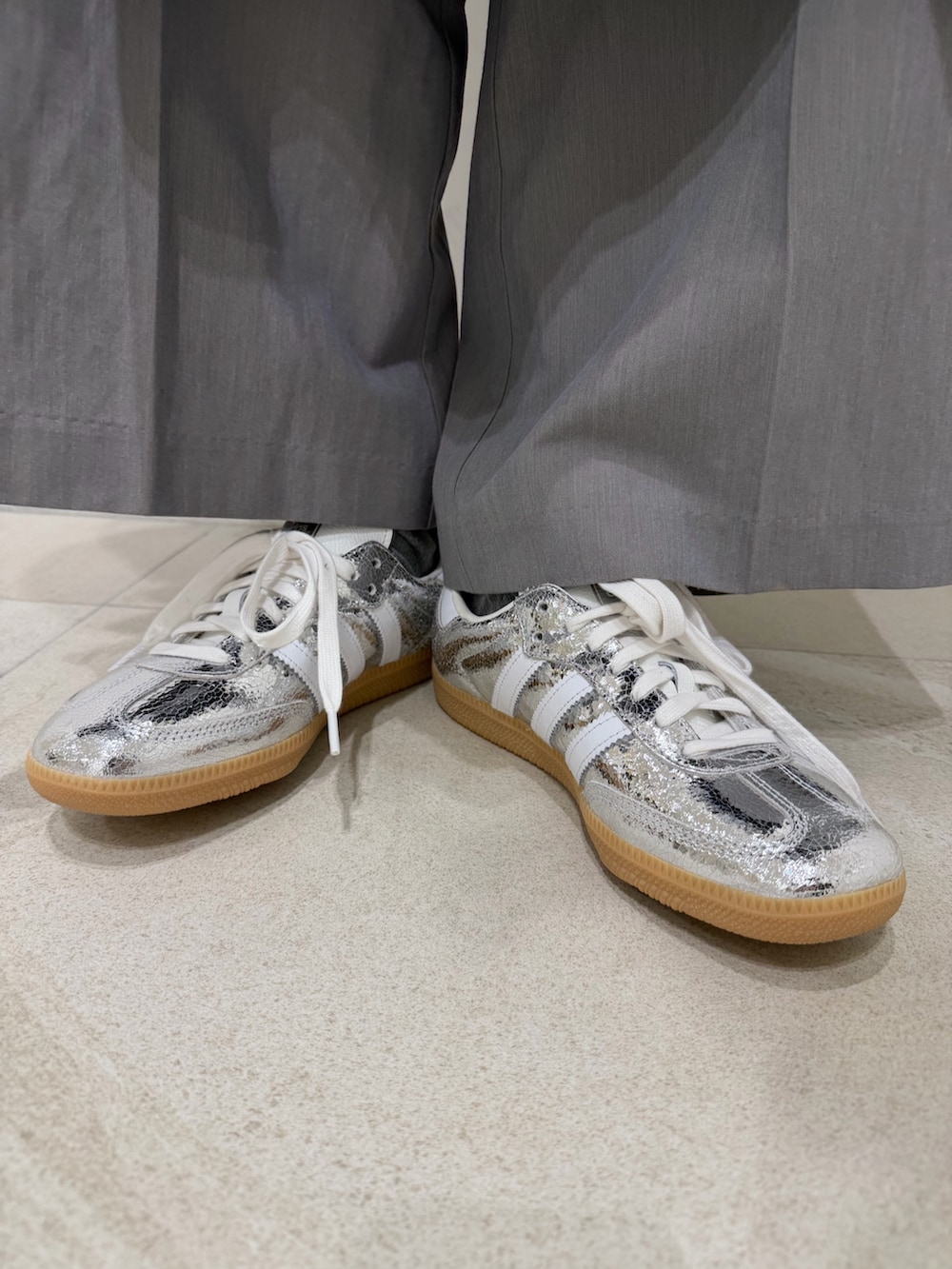 ブラック系のブルゾン、ブラック系のワンピース、シルバー系のスニーカーを着用したレディースの冬コーディネートの4枚目の写真