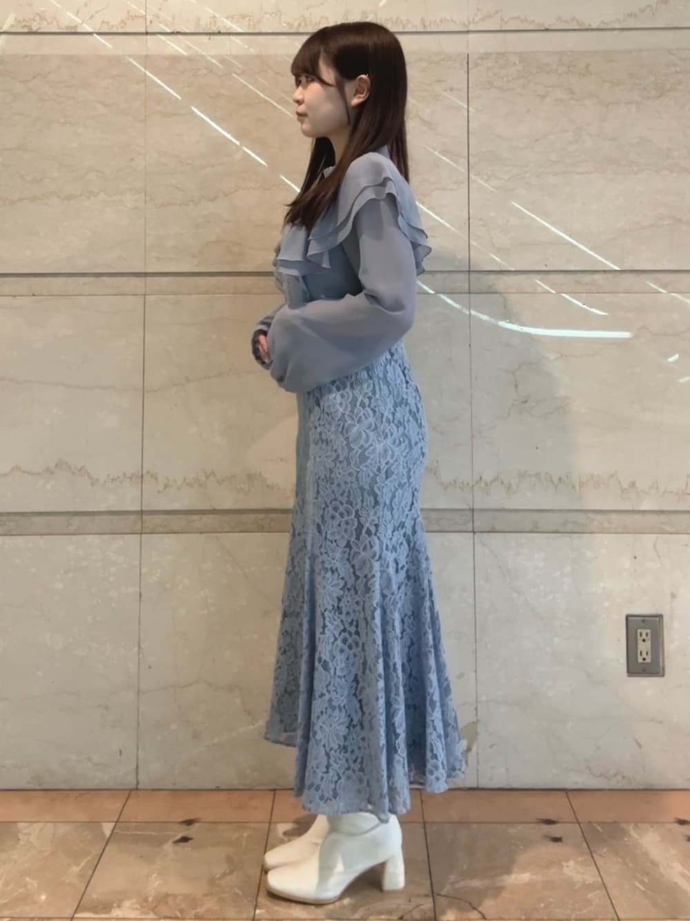 ブルー系のドレス、ホワイト系のブーツを着用したレディースの冬コーディネートの3枚目の写真