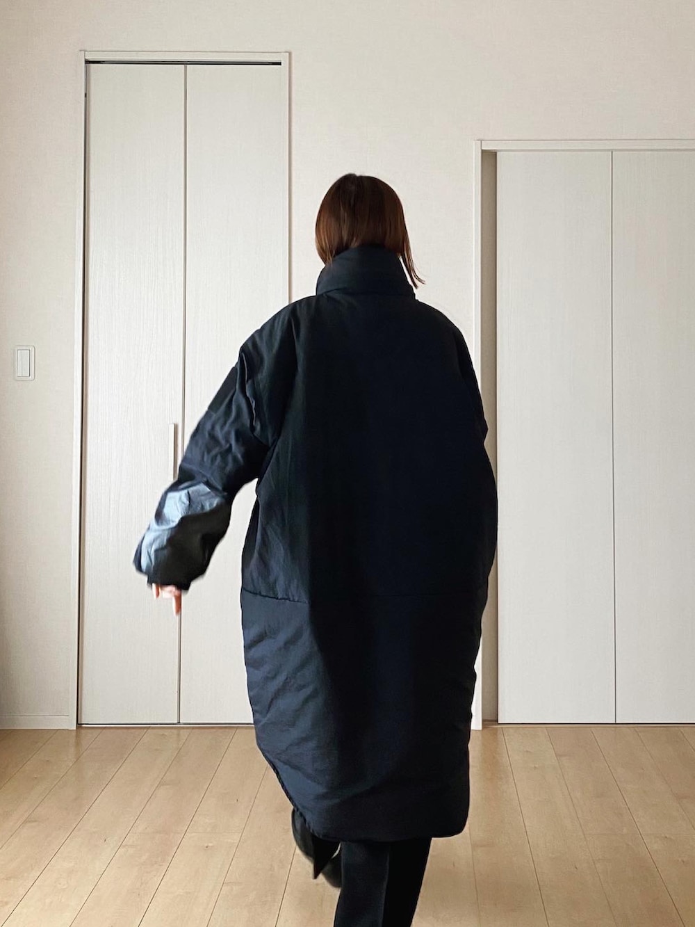 ブラック系のハンドバッグ、ブラック系のダウンジャケット/コート、ブラック系のその他パンツを着用したレディースの冬コーディネートの3枚目の写真