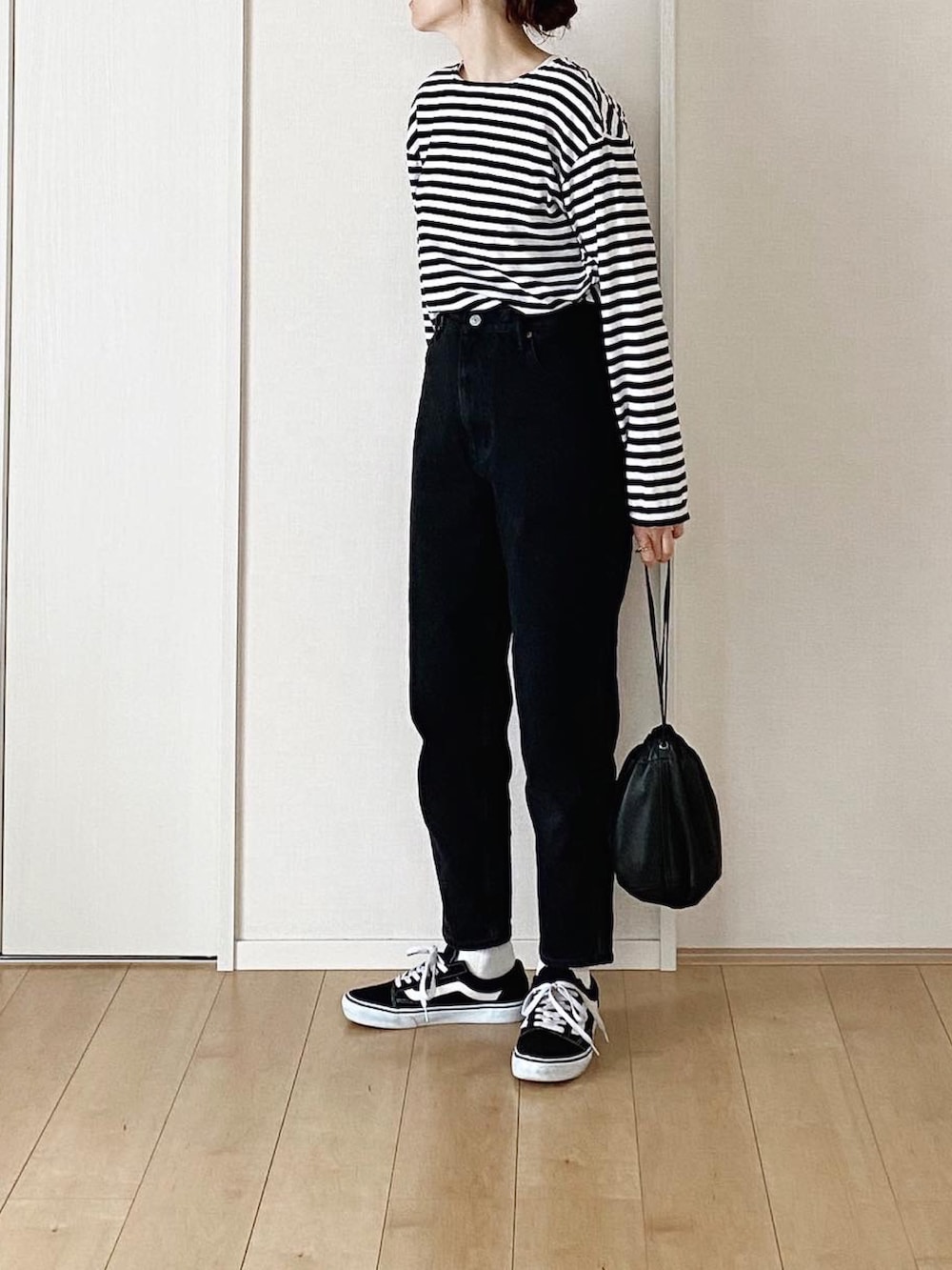 ブラック系のモッズコート、ブラック系のデニムパンツ、ブラック系のスニーカーを着用したレディースの冬コーディネートの2枚目の写真